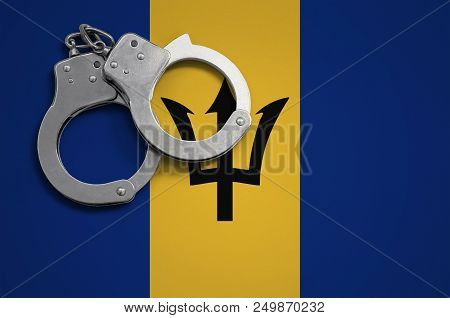 Barbados Flag  And Police Handcuffs. The Concept Of Crime And Offenses In The Country.