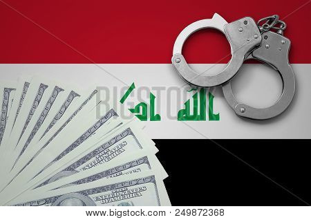 Iraq Flag  With Handcuffs And A Bundle Of Dollars. The Concept Of Illegal Banking Operations In Us C