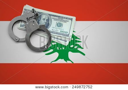 Lebanon Flag  With Handcuffs And A Bundle Of Dollars. The Concept Of Breaking The Law And Thieves Cr