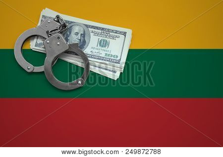Lithuania Flag  With Handcuffs And A Bundle Of Dollars. The Concept Of Breaking The Law And Thieves 