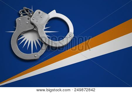 Marshall Islands Flag  And Police Handcuffs. The Concept Of Crime And Offenses In The Country.