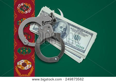 Turkmenistan Flag  With Handcuffs And A Bundle Of Dollars. Currency Corruption In The Country. Finan