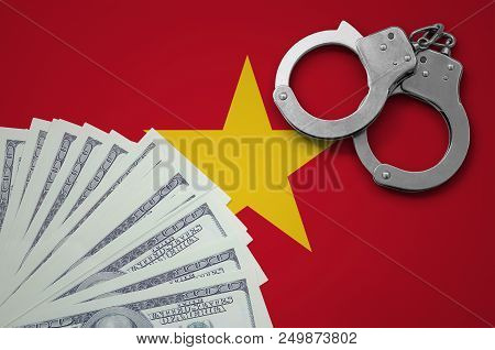 Vietnam Flag  With Handcuffs And A Bundle Of Dollars. The Concept Of Illegal Banking Operations In U