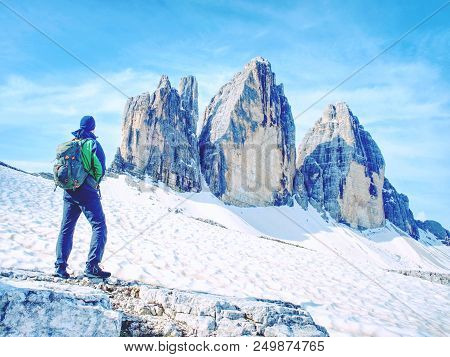 Backpacker On Trip Aound  Tre Cime Di Lavaredo In Sunny April  Morning. View From Tour Around Popula