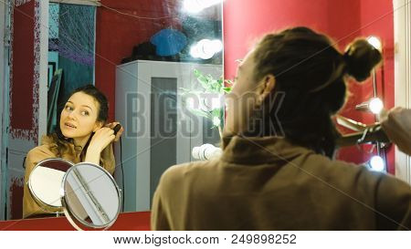 Young Beautiful Girl Curls Curls On A Curling Robe In The Dressing Room, The Artist Prepares For A P