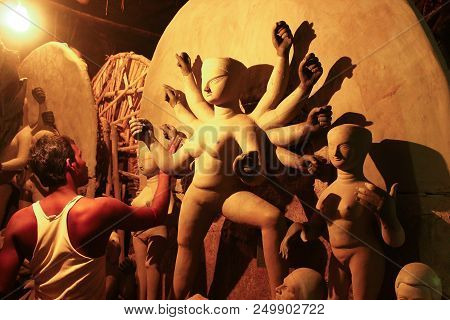 Kumartuli,west Bengal, India, July 2018.an Clay Scuplture Artist Working On A Clay Idol Of Goddess D