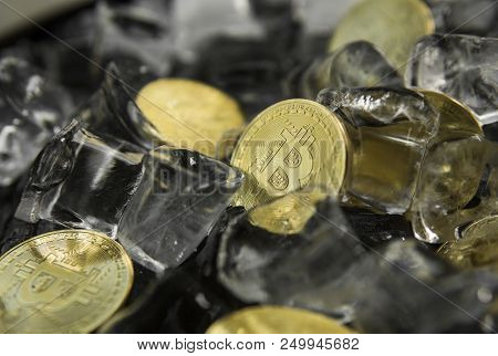 Golded Bitcoins On Ice Background. The Concept Of The Exchange In Winter. Freeze. Blockchain Mining.