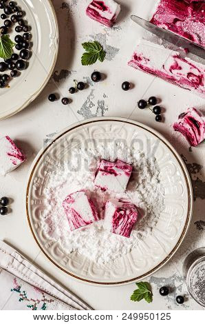 Blackcurrant Swirl Marshmallow In A Plate With Icing Sugar