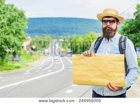 Pick Me Up. Man Bearded Hitchhiker Stand At Edge Of Road With Blank Paper Sign, Copy Space. Benefits