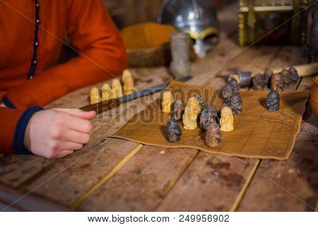 Close Up Shot - Two Men In Russian Ethnic Suit Playing Medieval Popular Strategy Board Game - Tafl. 