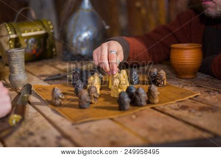 Close Up Shot - Two Men In Russian Ethnic Suit Playing Medieval Popular Strategy Board Game - Tafl. 