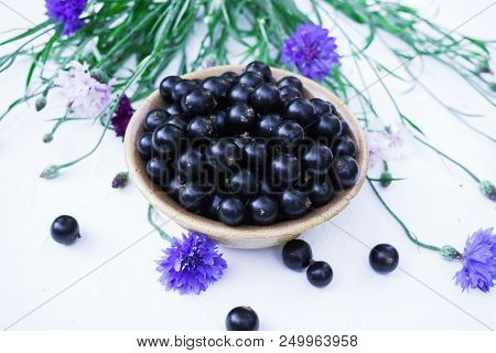 Berries Of A Tasty, Large Black Currant On A Table In A Small Plate