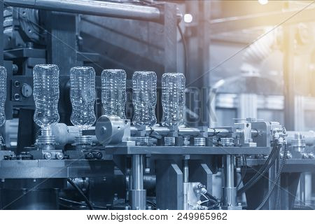 The  Plastic Bottles Manufacturing Process At The Drinking Factory In The Light Blue Scene. Drinking