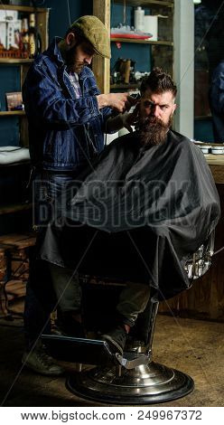 Hipster Lifestyle Concept. Hipster Client Getting Haircut. Barber With Clipper Trimming Hair On Temp
