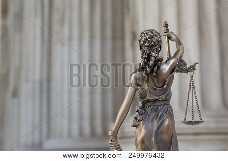 The Statue Of Justice Themis Or Iustitia, The Blindfolded Goddess Of Justice Against An Ionic Order 