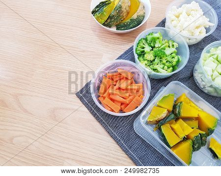 Various Chop Vegetable Preparation For Cooking On Wooden Table With Blue Jean Apron