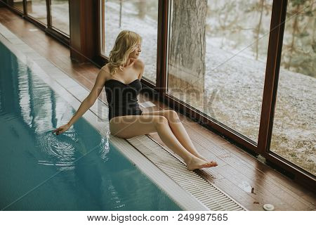 Pretty Young Woman Relaing By The Swimming Pool