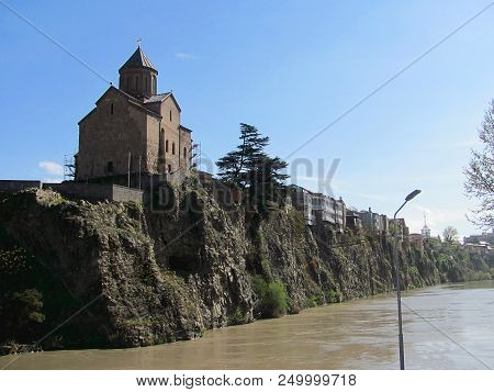 Metekhi St. Virgin Church And King Gorgasali Statue Over Kura River, Tbilisi, Georgia