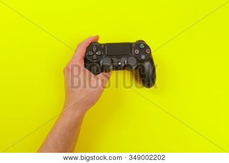 Russia, Oktober 24 2019: Male Hands Holding A Ps4 Controller, Sony Playstation 4 Game Console.