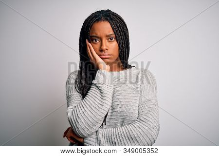 Young african american woman standing casual and cool over grey isolated background thinking looking tired and bored with depression problems with crossed arms.