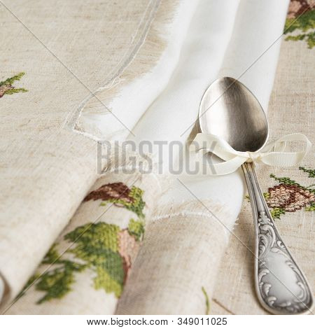 Vintage Russian Silverspoon With Silk Ribbon On Linen Napkin. Old Fashion Heroloom Silverware