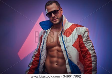 Portrait Of Muscular Man In Sunglasses Over Neon Background.
