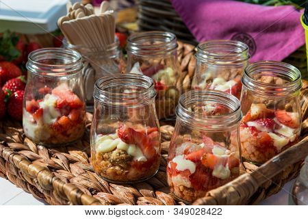 Delicious Strawbery Desert With Granola And Chocolate In Cute Jar.