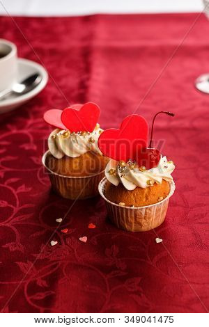 Redvelvet Cupcakes With Cream Cheese Frosting And A Red Heart On A Red Background
