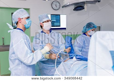 Arthroscope Surgery. Orthopedic Surgeons In Teamwork In The Operating Room