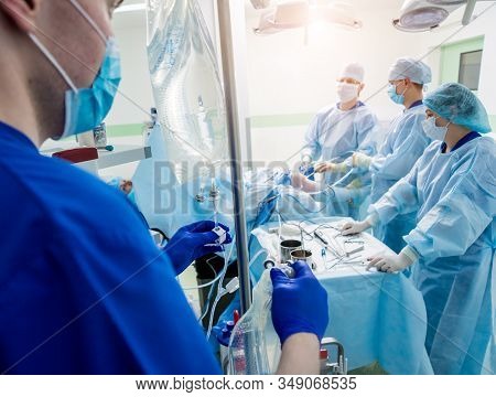 Arthroscope Surgery. Orthopedic Surgeons In Teamwork In The Operating Room