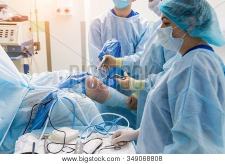 Arthroscope Surgery. Orthopedic Surgeons In Teamwork In The Operating Room