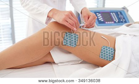 Session Of Myostimulation On Womens Legs In A Cosmetology Clinic.