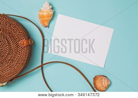 Seashells And Ratan Bag On Blue Background, Top View.