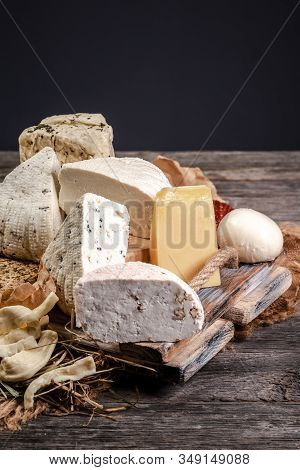 French Cheese Platter With Spanish Dulce De Membrillo On A Wooden Board.