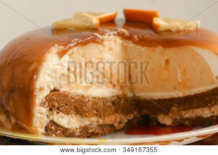 Cut Orange Caramel Mousse Cake With Cream Cheese Mascapone And Chocolate Glaze With Orange Pieces Cl