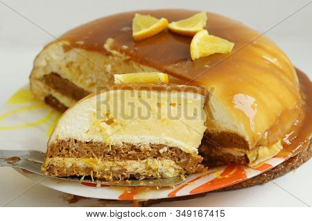 Cut Orange Caramel Mousse Cake With Cream Cheese Mascapone And Chocolate Glaze With Orange Pieces Cl