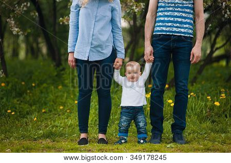 Happy Family Mother, Father, Little Son For A Walk In The Summer Park.happy Young Family Spending Ti