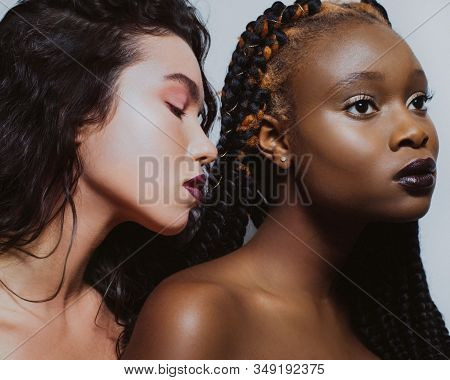 Beauty Portrait Of Africans And Europeans Girls With Bare Shoulders And Fashionable Make Up Stand Cl