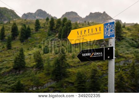 Saint-luc, Valais, Switzerland - August 8 2018: Singpost With Directions For The Neptune Statue On T