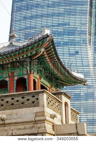 Seoul, Republic of Korea - March 2019: Dongshipjagak, ancient watchtower, Seoul landmark. Modern office buildings in the background.