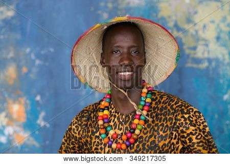 Closeup Portrait Of Handsome African Man In Traditional Fulani Hat And Colorful Clothes