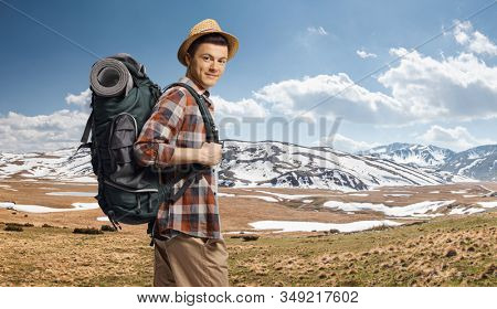 Young guy hiking with a backpack on Shara mountain with snow, Macedonia