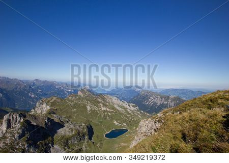 View Over The Central Swiss Alps With A Lake In Summer
