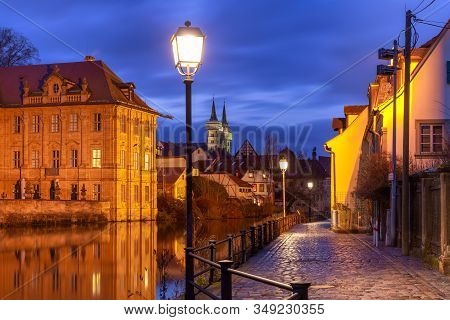 Scenic View Of Old Town And Michelsberg Monastery Over The Regnitz River At Night In Bamberg, Bavari