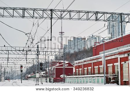 Industrial Landscape - Snow-covered Railway Station With Vintage Workshops In The Foreground And Mod