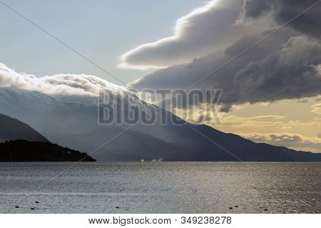 A Series Of Lake Landscapes. Attractive Skies And Mountain Hills. And Inexplicable Splashes On The L