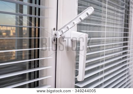 A Handle And A Restrictor, Window Stopper Or Limiter On Pvc Double Glazed Window With Horisontal Alu