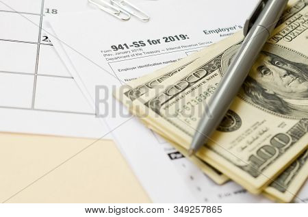 Irs Form 941-ss Employers Quarterly Federal Tax Return Blank Lies With Pen And Many Hundred Dollar B