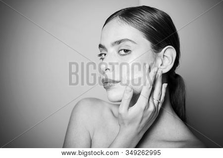 Sexy Healthy Woman Applying Cream Or Lotion With Moisturizer To Skin Face. Perfect Pure Skin. Health