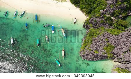 Sandy Beach With Tourists And Tropical Island By Atoll With Coral Reef, Top View. Lahos Island, Cara